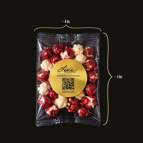 Packaged raspberry cheesecake popcorn with size measurements on a black background